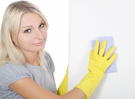 Cleaning team sanitizing shared office surfaces and desks