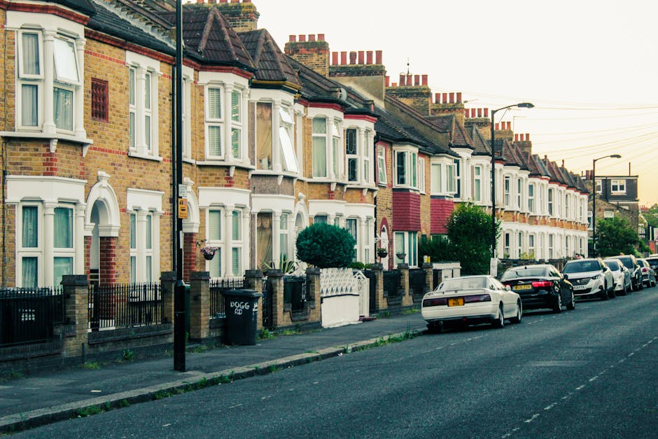 A row of traditional Victorian terraced houses on King Road Chelsea featuring brick facades with decorative white window trims and bay windows. The houses have pitched tiled roofs with multiple red br